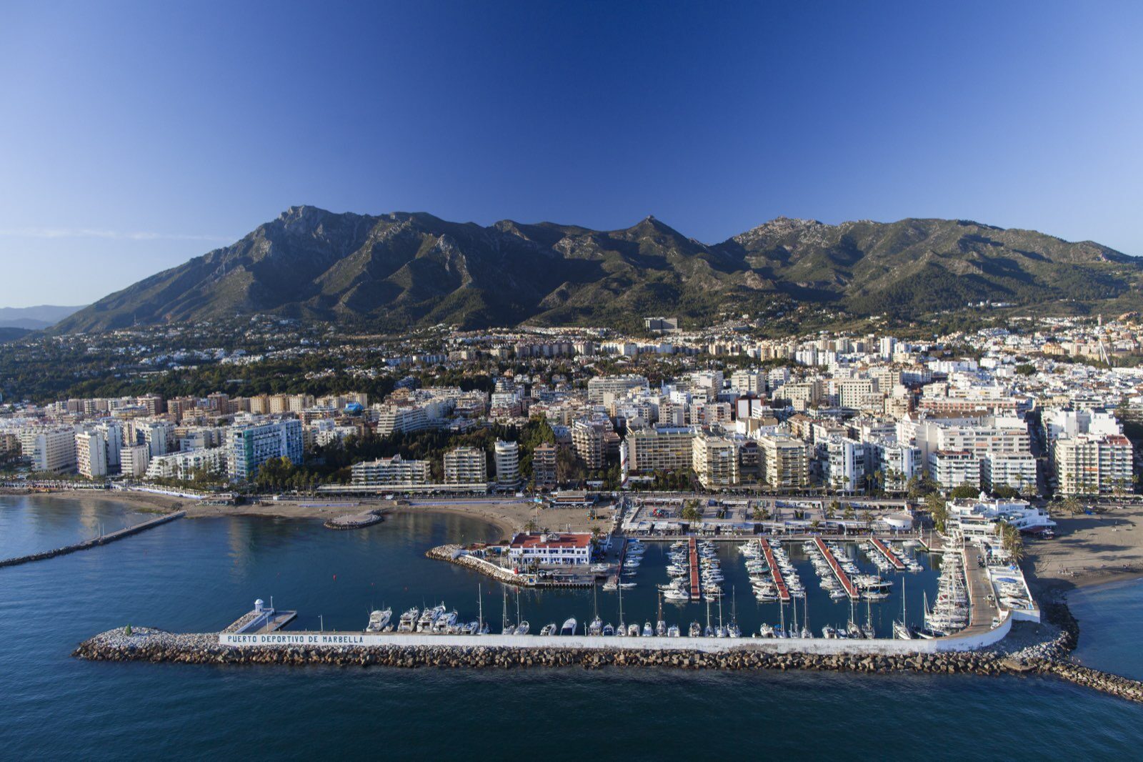 Marbella's marina, old town and Sierra Blanca mountains