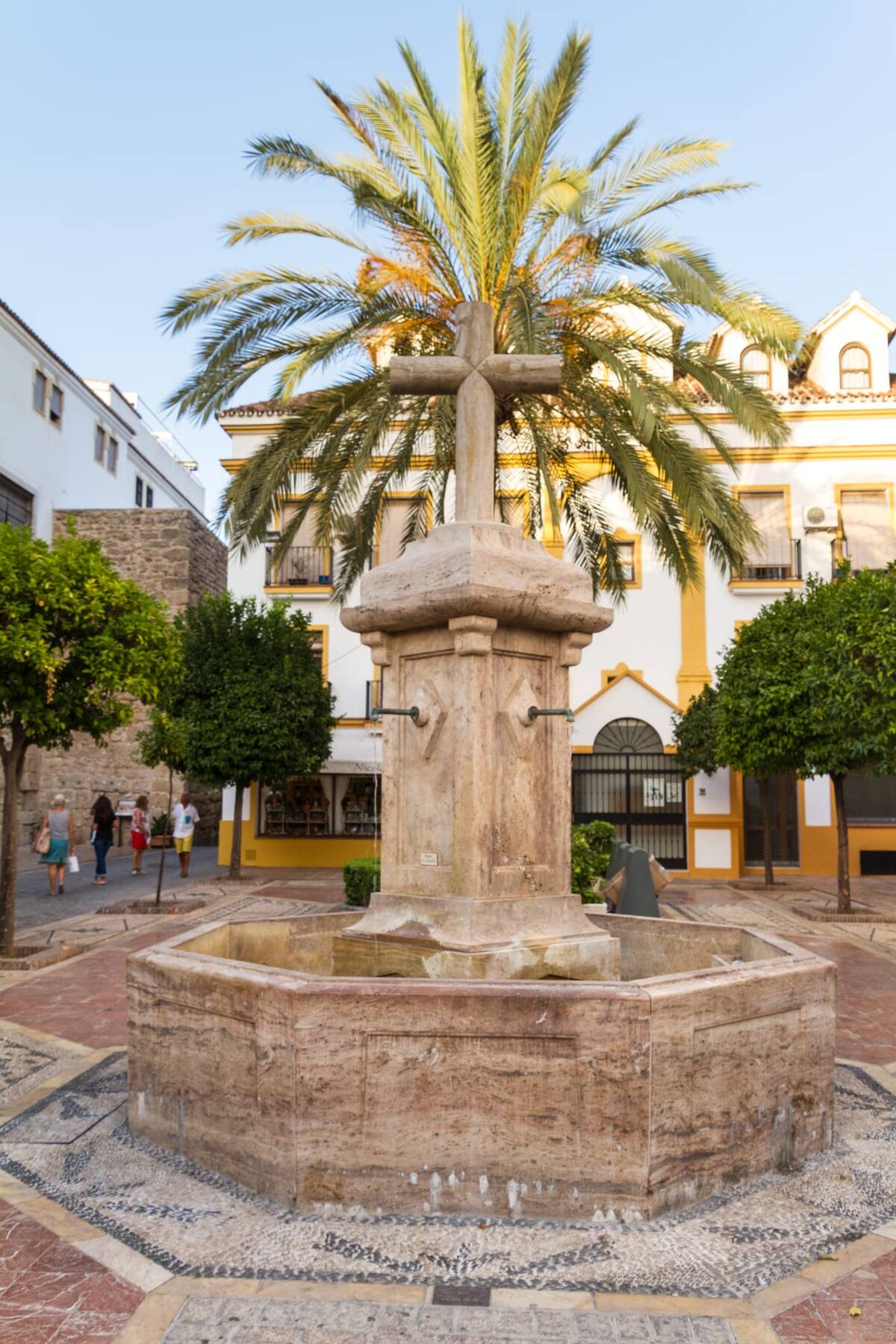 A fountain in Marbella's old town, orange trees in leaf