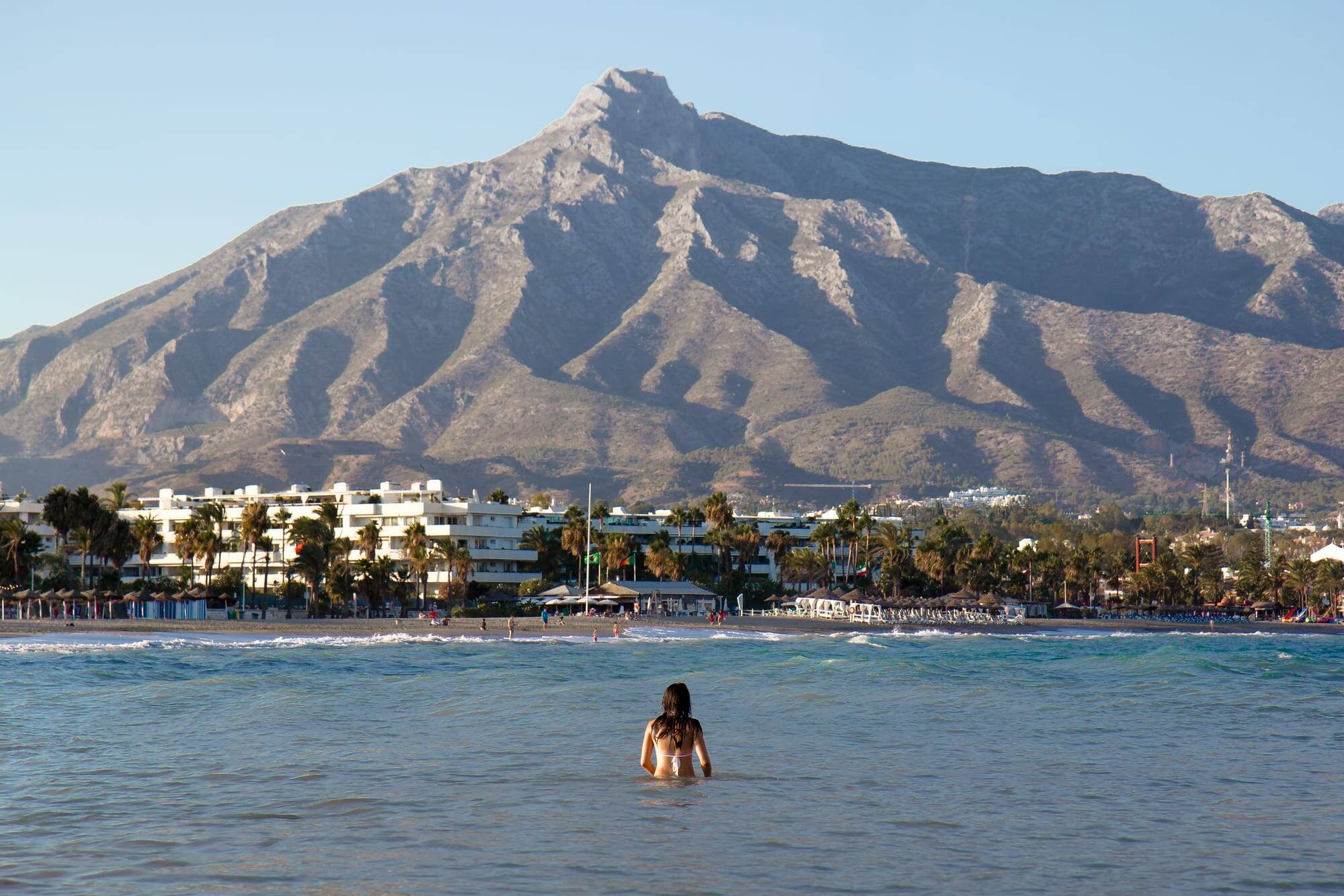 The sea and the mountains behind Marbella under autumn haze
