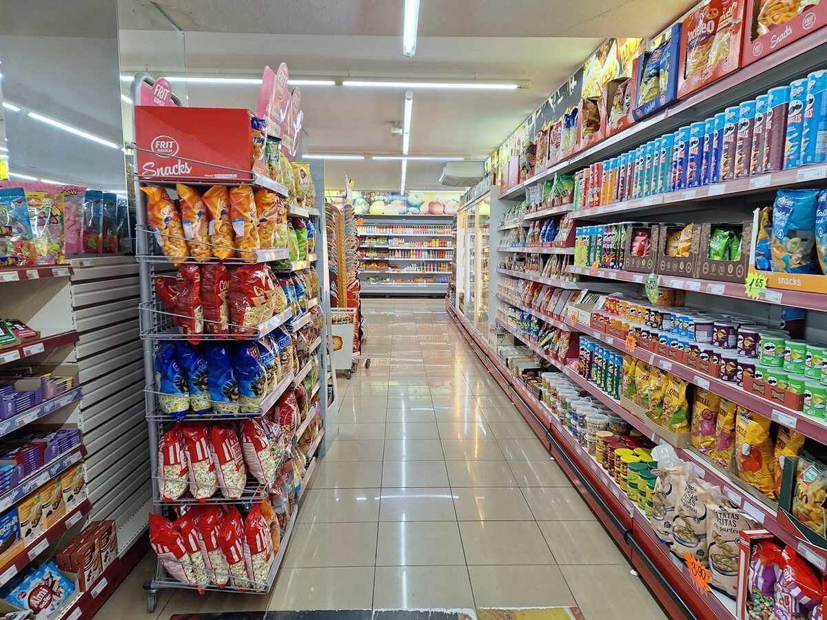 Supermarket aisle stocked with snacks and groceries in Spain