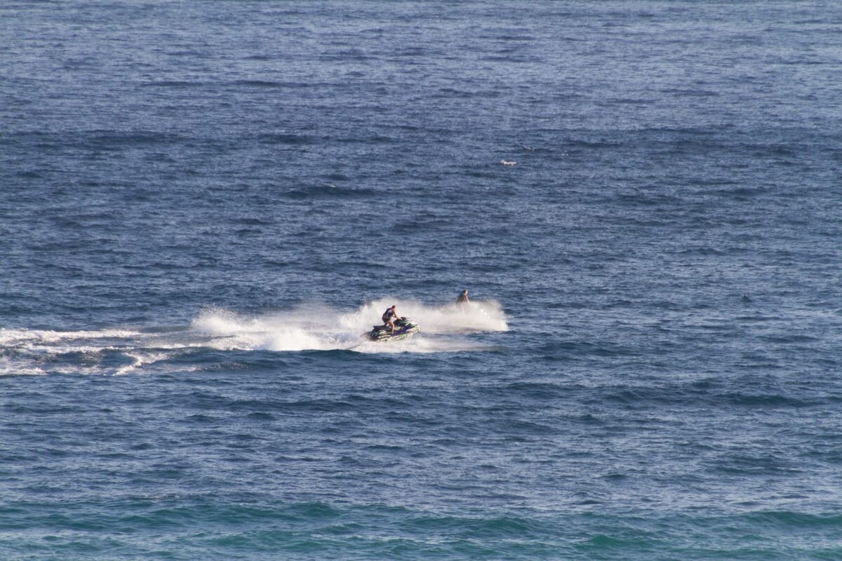 Two jet skis at speed off a Marbella beach