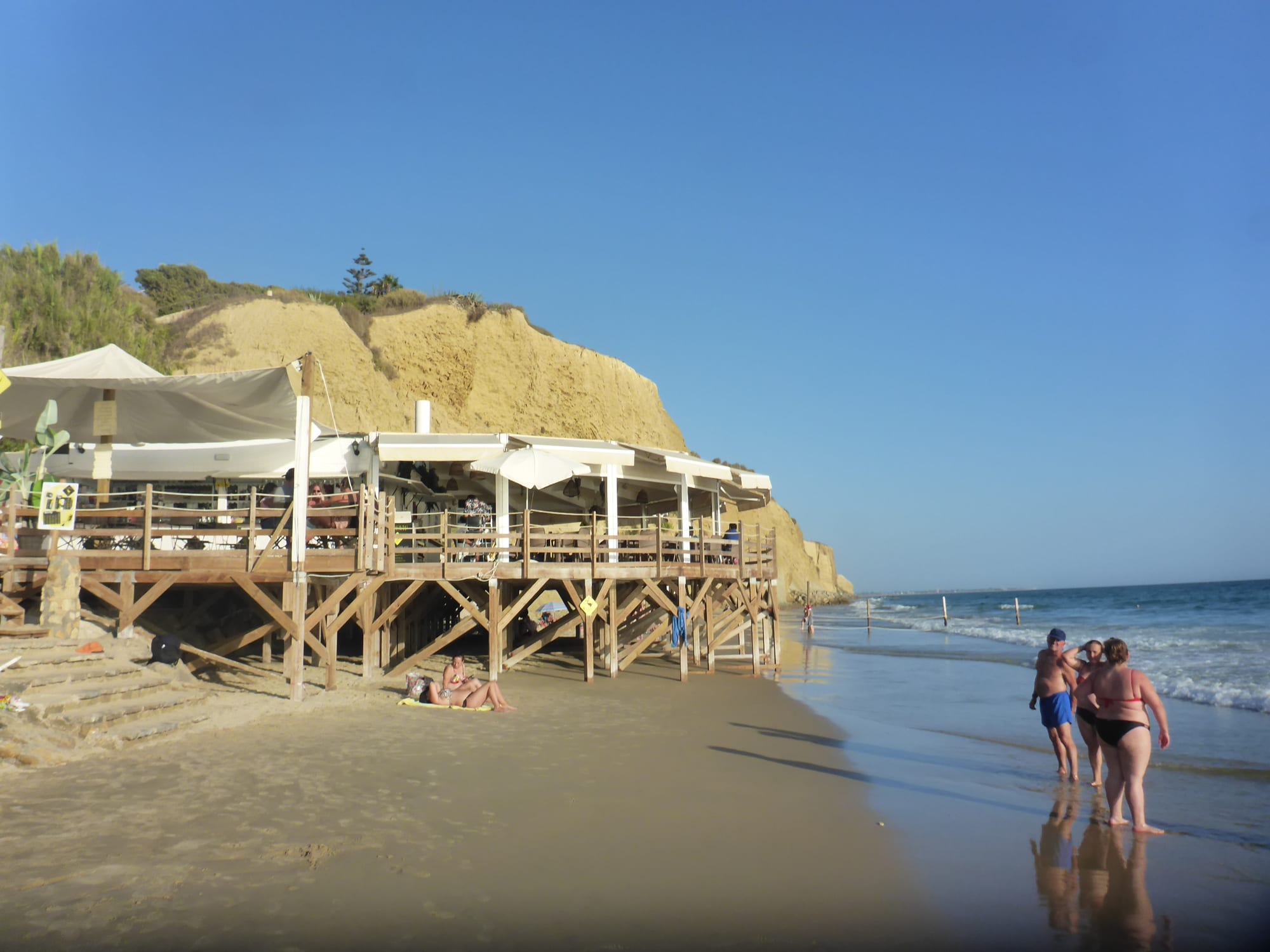 A wooden chiringuito beach bar above the sand in Andalusia